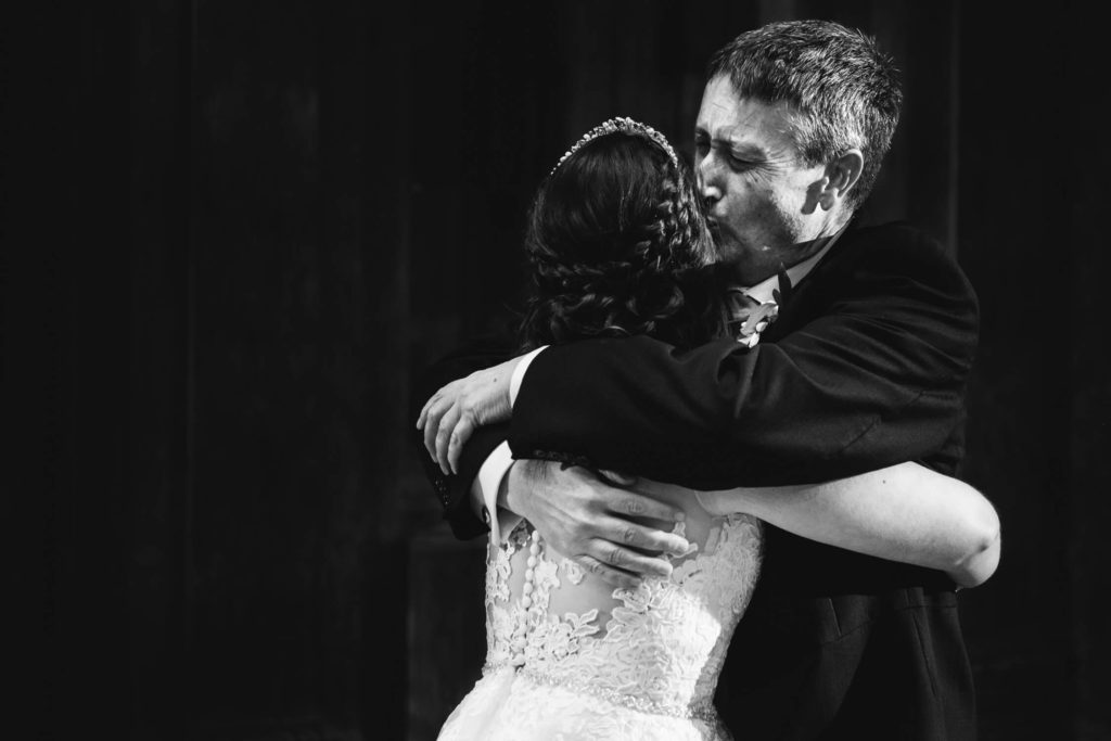 Father of bride kisses daughter after their dance at Fawsley Hall
